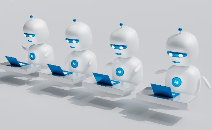 a group of white robots sitting on top of laptops